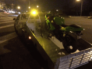 Emergency Breakdown Service: "A 24/7 emergency motorcycle towing logo emphasizing around-the-clock service availability."